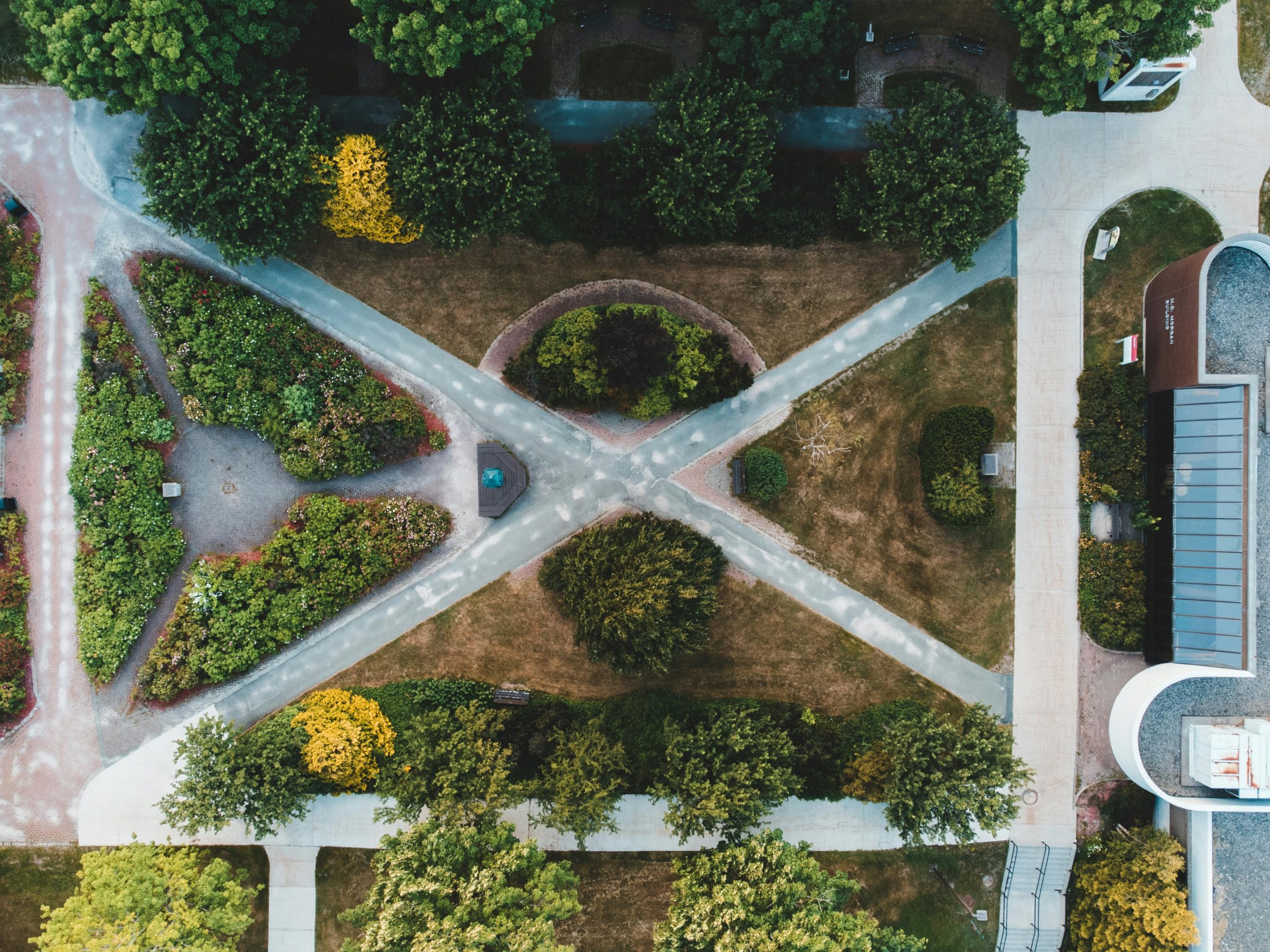Explore symmetrical garden pathways captured from above with lush greenery.